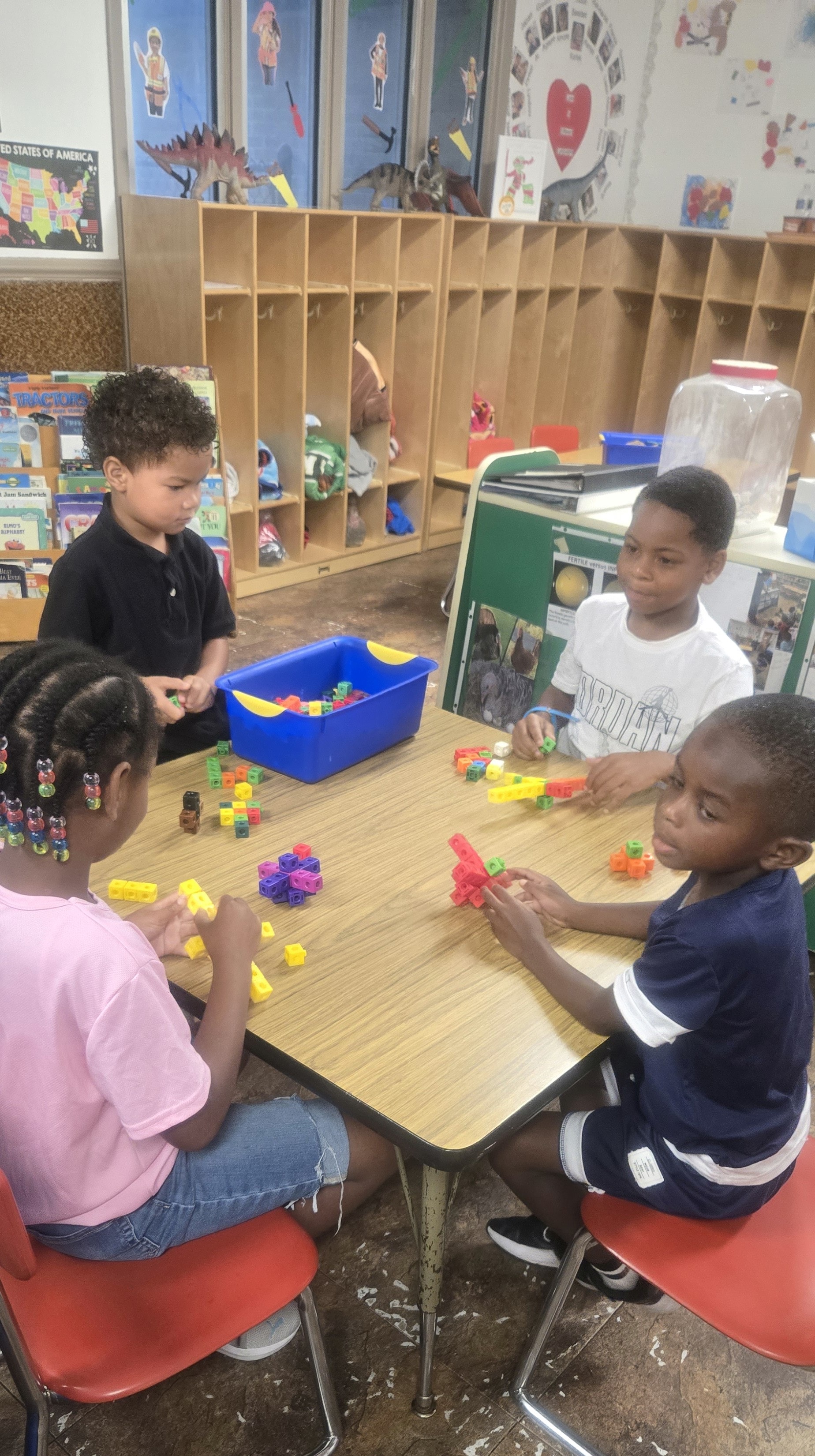 Children building with colorful blocks at a classroom table
